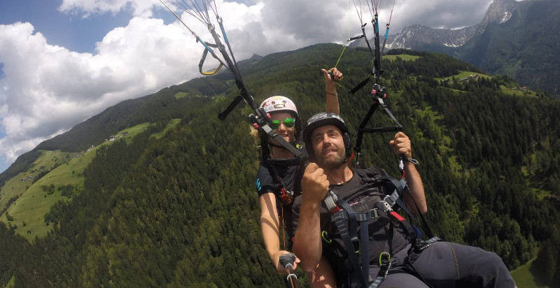 Pilota professionista guida un volo tandem in parapendio sopra Merano
